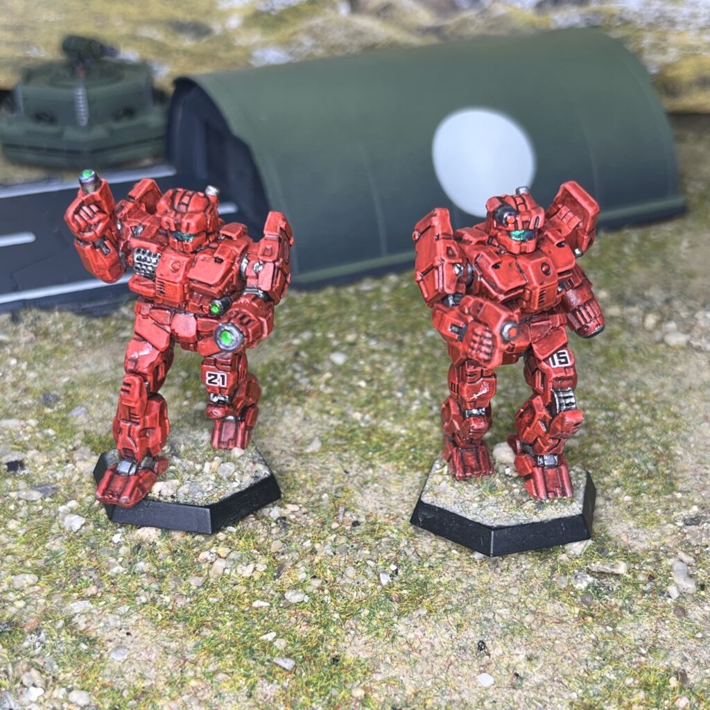a pair of Charger miniatures painted red
