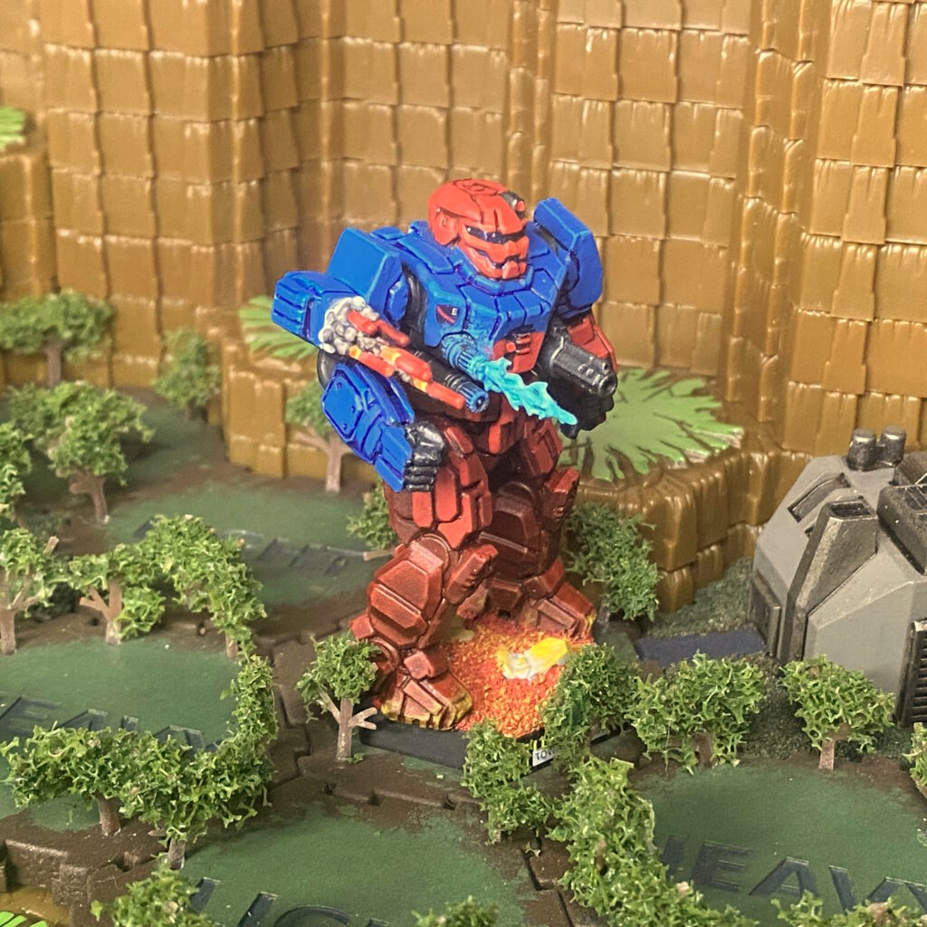 a Banshee miniature kitbashed with weapon effects, panted in red with blue shoulders and upper torso