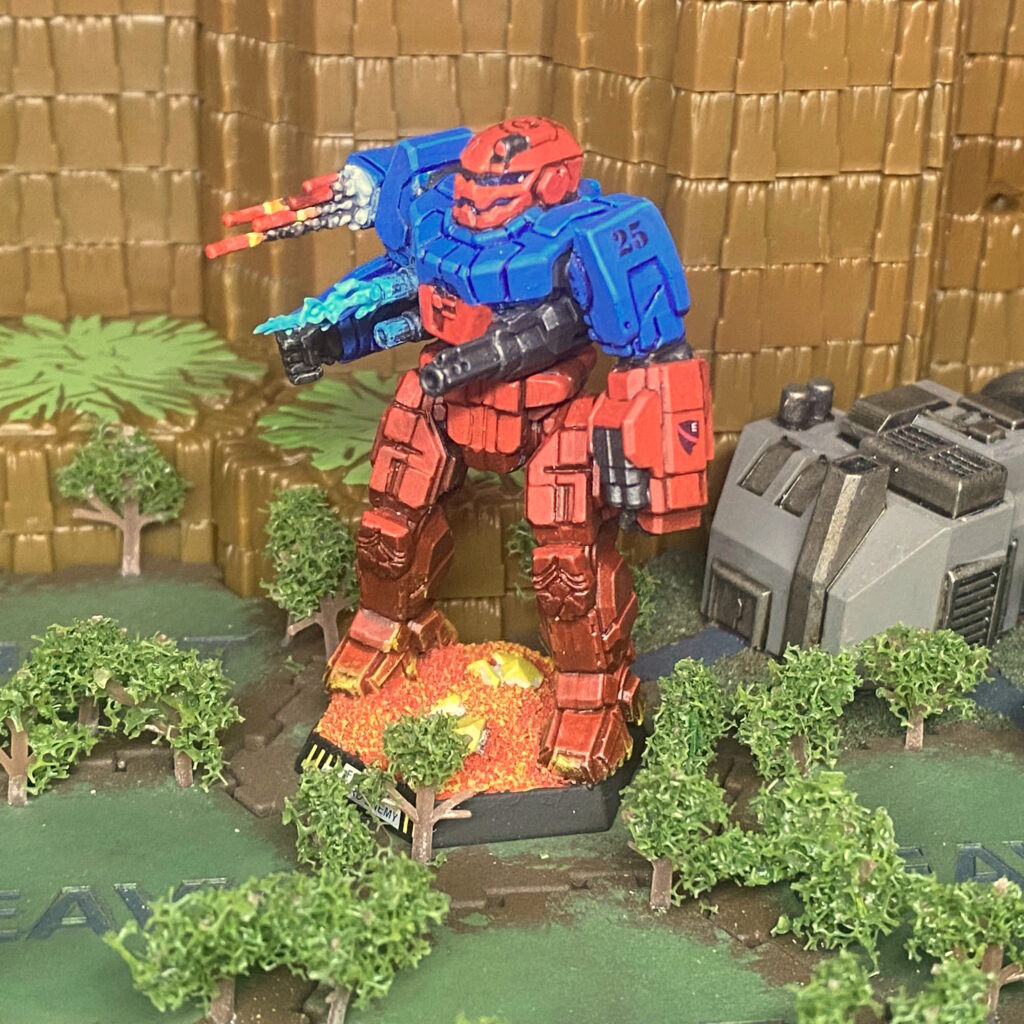 a Banshee miniature kitbashed with weapon effects, panted in red with blue shoulders and upper torso