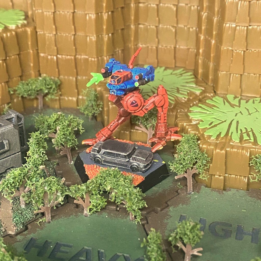 a Locust miniature kitbashed with weapon effects, painted with red legs and blue body