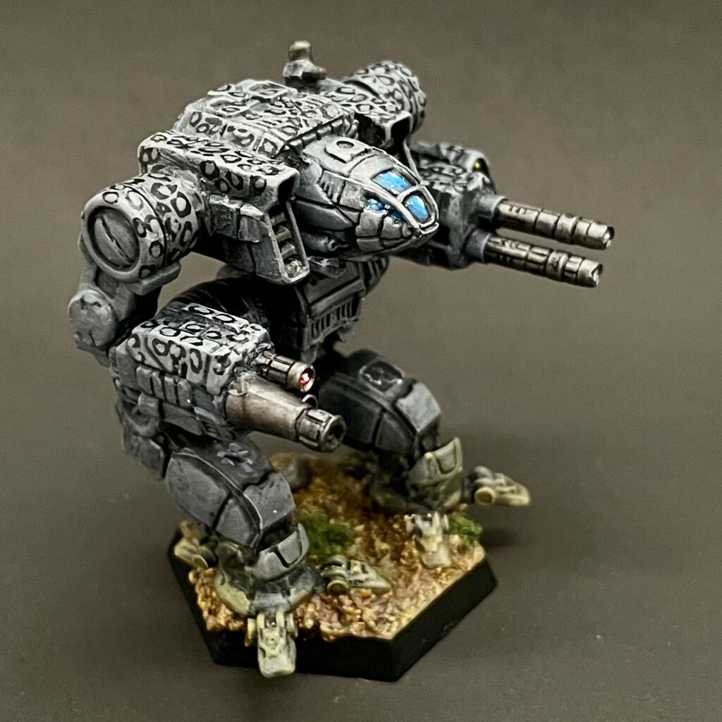 a kitbashed Iron Cheetah miniature painted in grey with white spots ringed in black