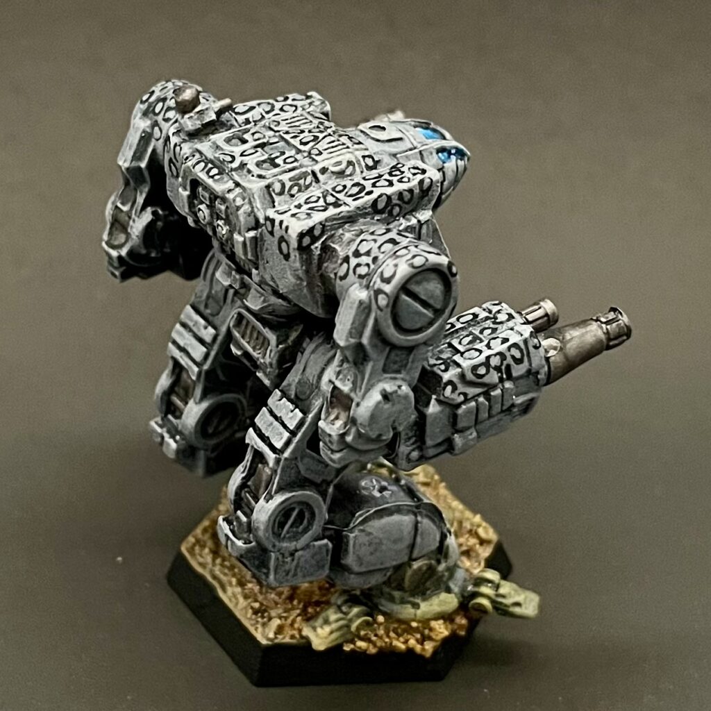 a kitbashed Iron Cheetah miniature painted in grey with white spots ringed in black