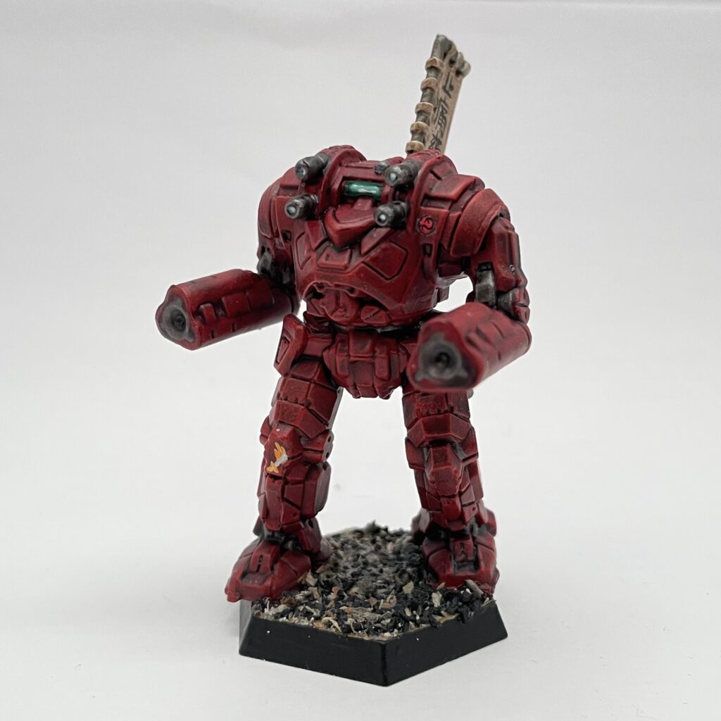 a Gunslinger miniature painted in red with gold accents and a kitbashed banner