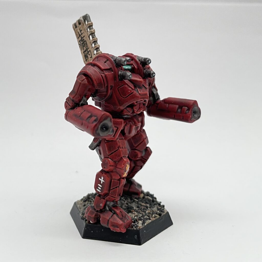 a Gunslinger miniature painted in red with gold accents and a kitbashed banner