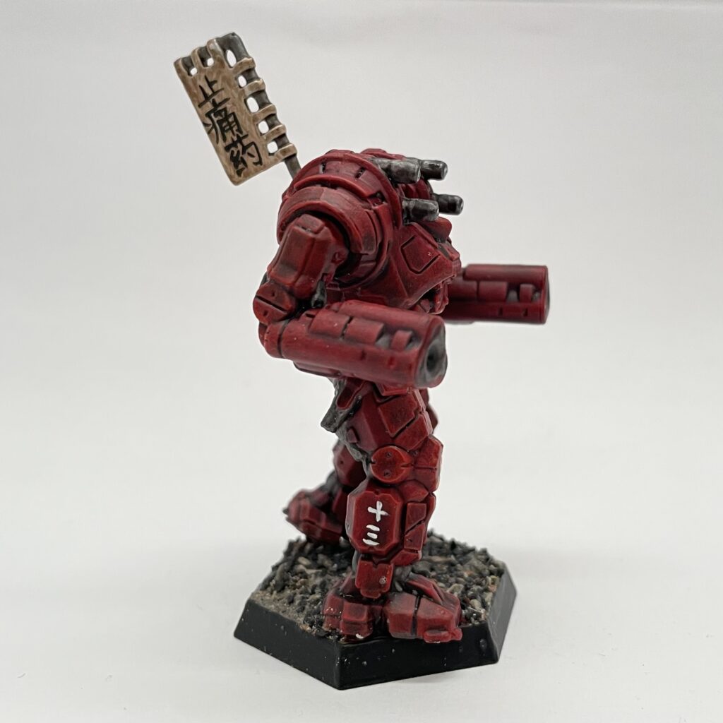 a Gunslinger miniature painted in red with gold accents and a kitbashed banner