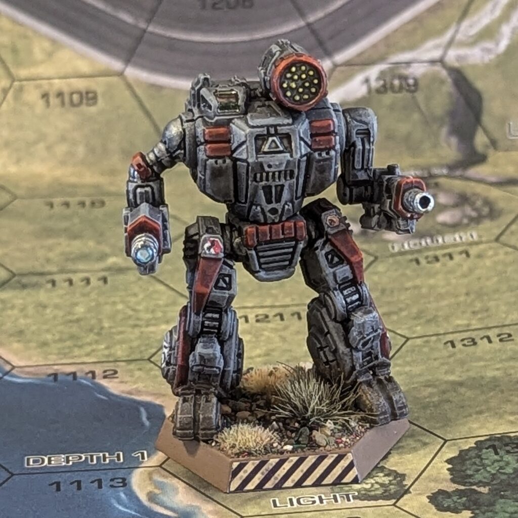 a Summoner miniature painted grey with red accents