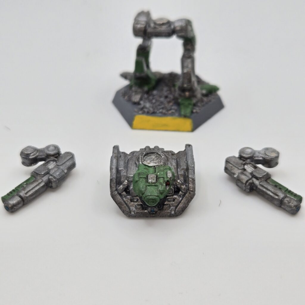 Adder miniature painted metallic grey with green accents. The torso and arms have been magnetized and disassembled