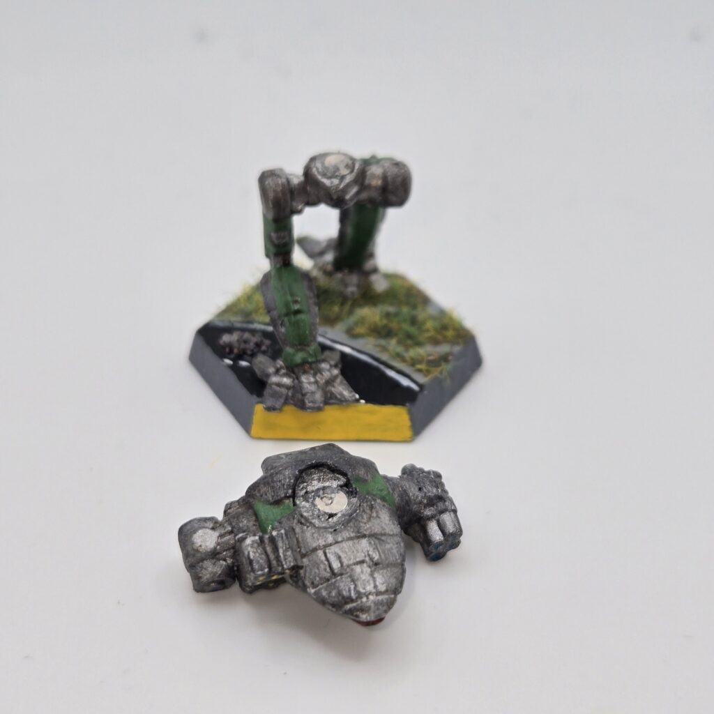 Fire Falcon miniature painted metallic grey with green accents. The torso has been magnetized and disassembled