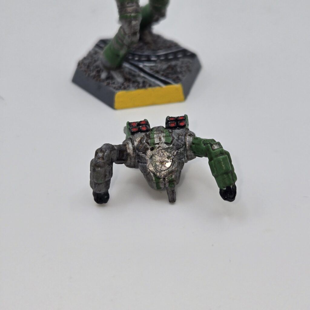 Ostscout miniature painted metallic grey with green accents. The torso has been magnetized and disassembled
