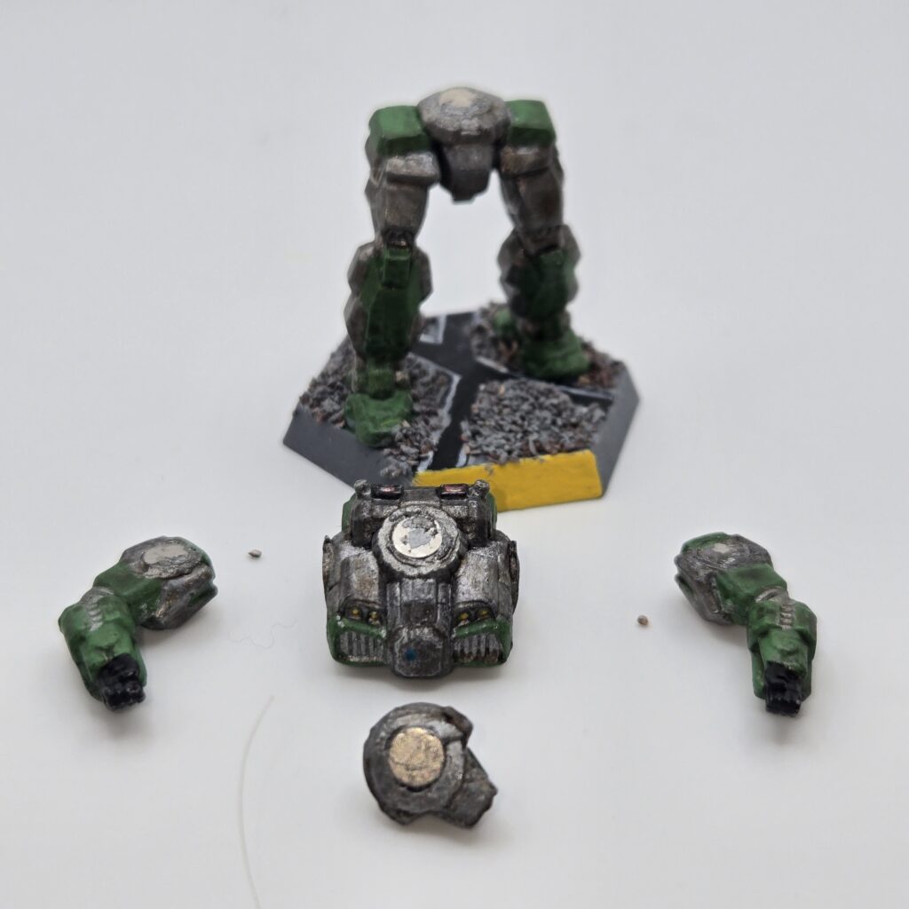 Shadow Hawk IIC miniature painted metallic grey with green accents. The torso and arms have been magnetized and disassembled