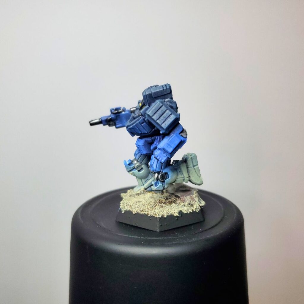 a Wolverine miniature painted in a grey-to-blue gradient