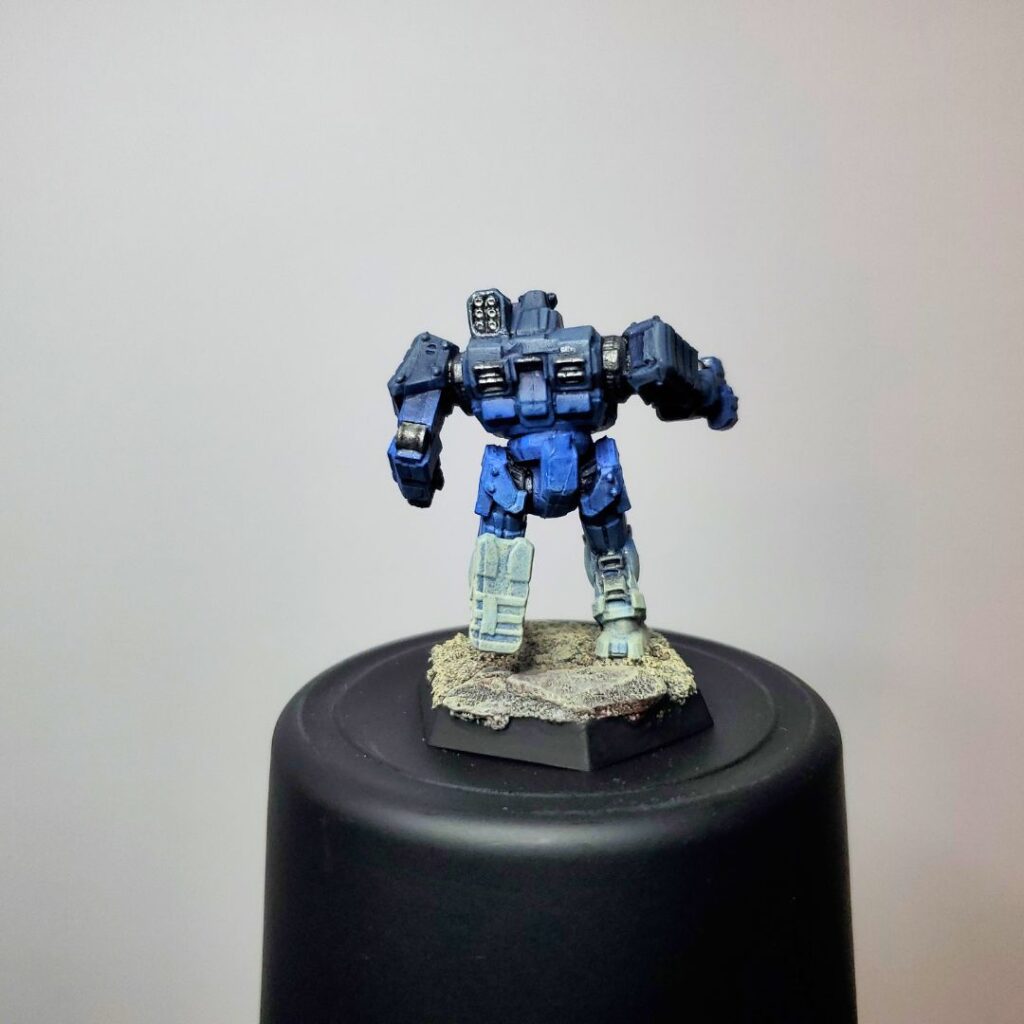 a Wolverine miniature painted in a grey-to-blue gradient