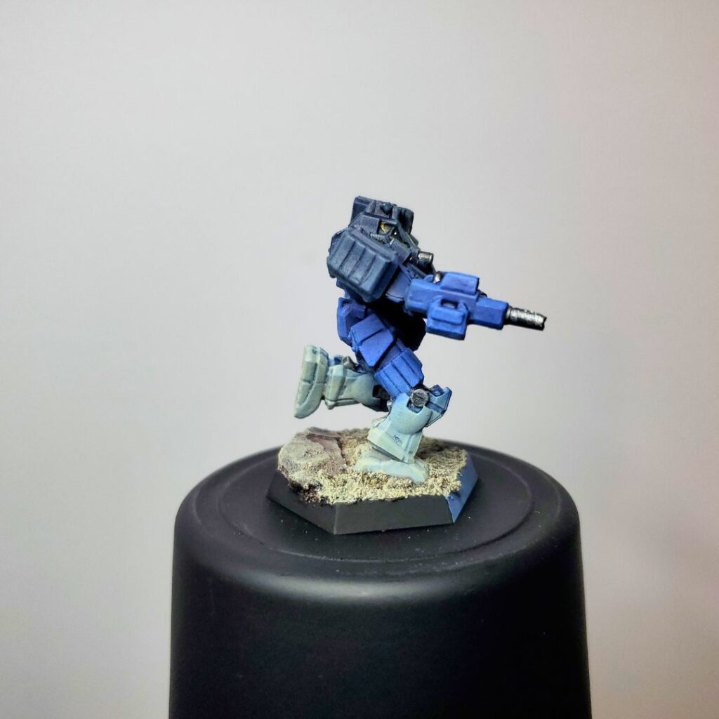 a Wolverine miniature painted in a grey-to-blue gradient