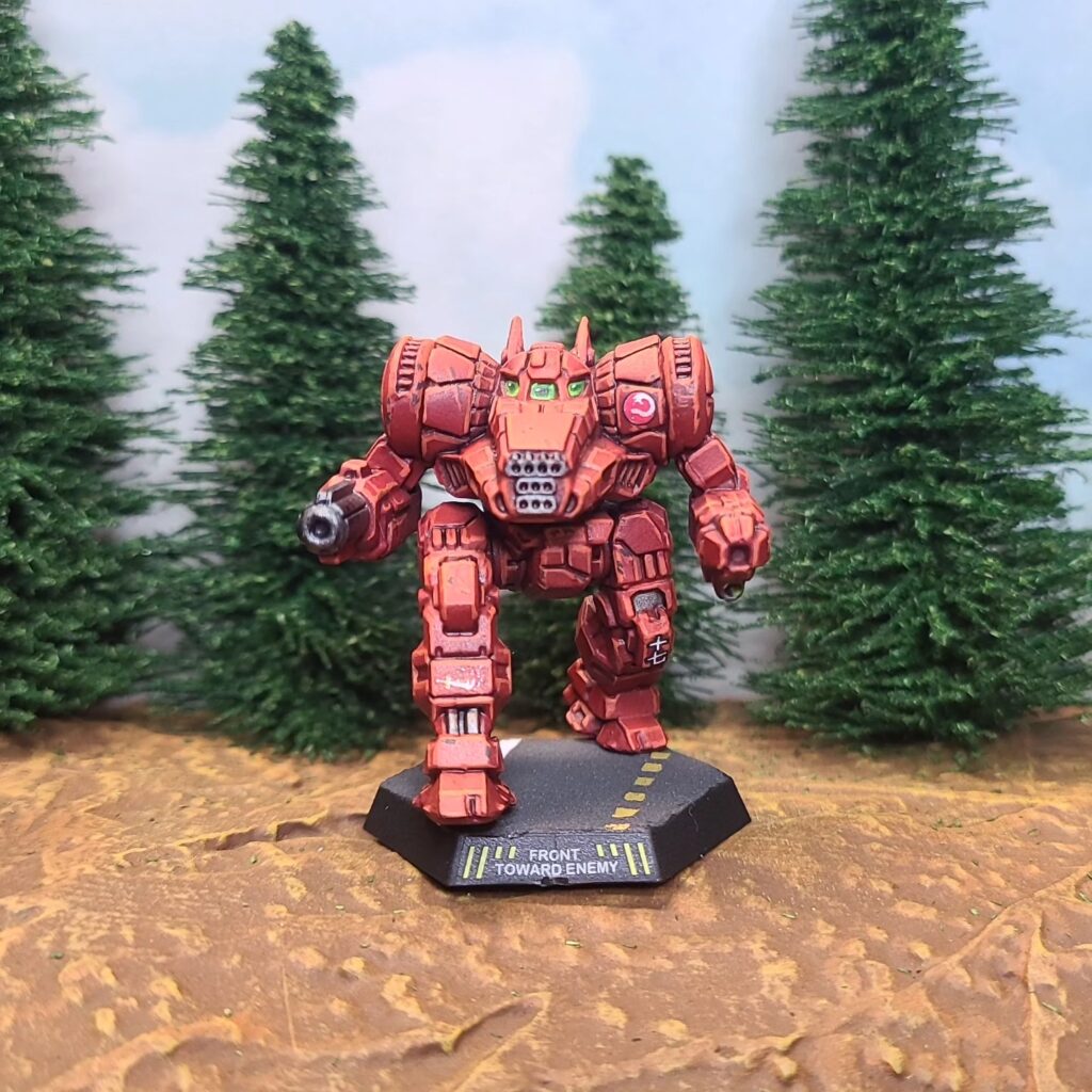 a Dragon miniature painted red with green cockpit accents