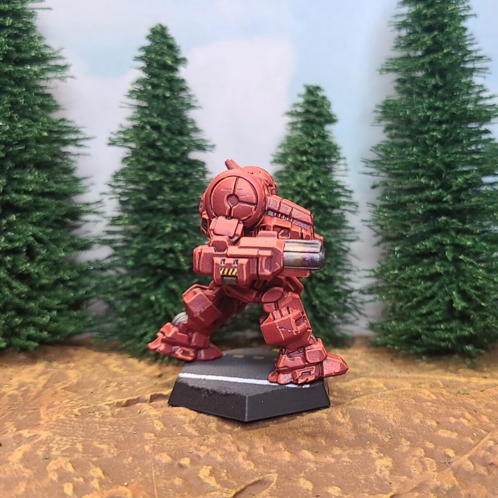 a Dragon miniature painted red with green cockpit accents