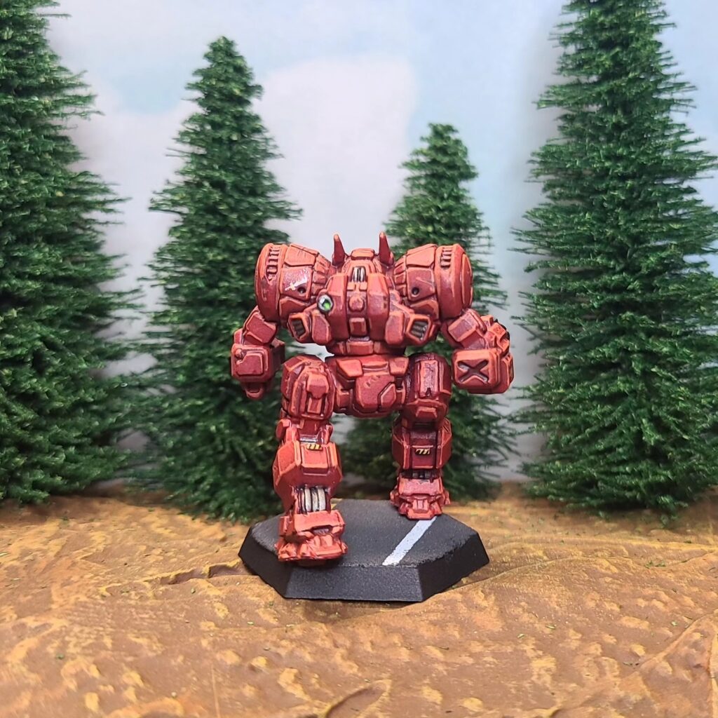 a Dragon miniature painted red with green cockpit accents