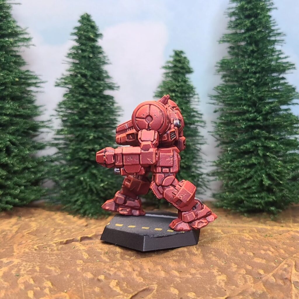 a Dragon miniature painted red with green cockpit accents