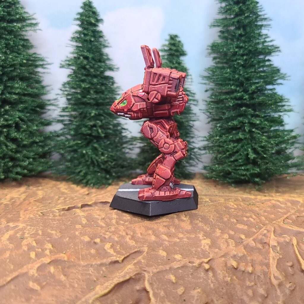 a Catapult miniature painted red with green cockpit accents
