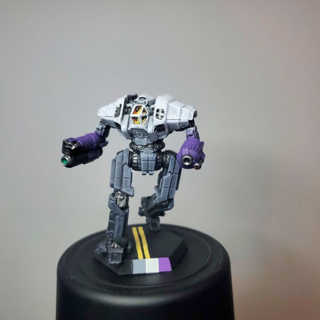 an Ymir miniature painted grey with white, black, and purple accents